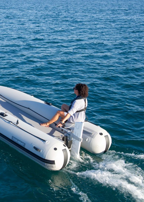 woman steering RemigoOne electric outboard