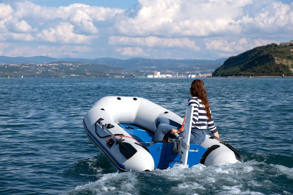 woman steering a RemigoOne electric outboard on the sea
