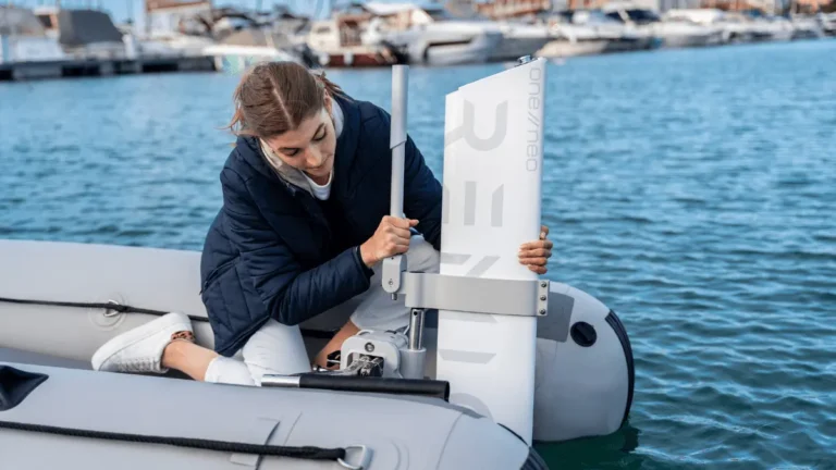 A woman setting up RemigoOne to her inflatable boat