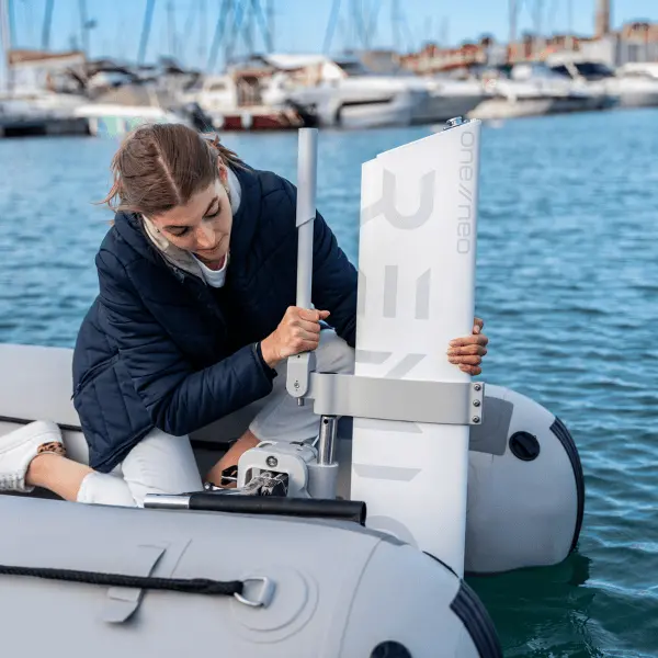 A lady installing her RemigoOne to her inflatable boat