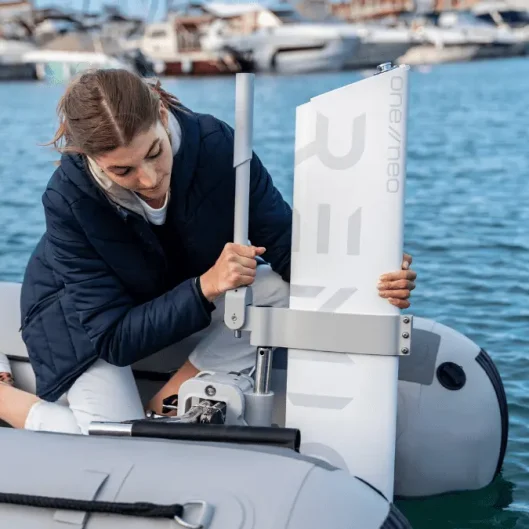 A woman setting up RemigoOne to her inflatable boat